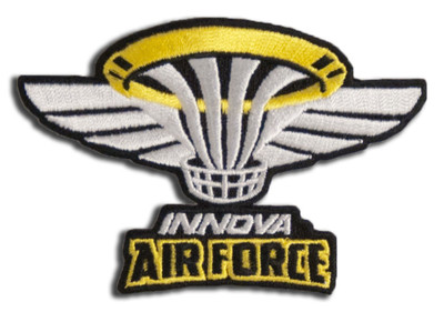 Patch with a small white and yellow basket in the middle and white wings spreading out to the sides, with the words "Innova Air Force" below it.